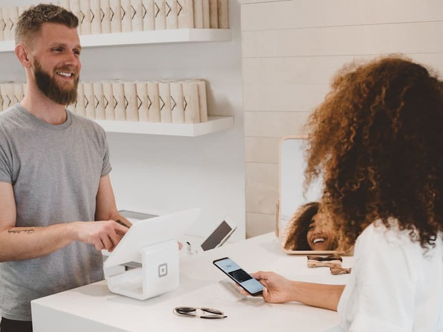 Commerçante encaissant un paiement par carte dans sa boutique